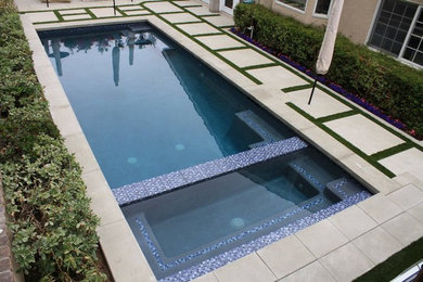 Inspiration for a large contemporary backyard stone and rectangular lap hot tub remodel in Los Angeles
