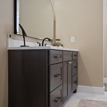 Warm and Cohesive Multi-Bathroom Design In Nokesville