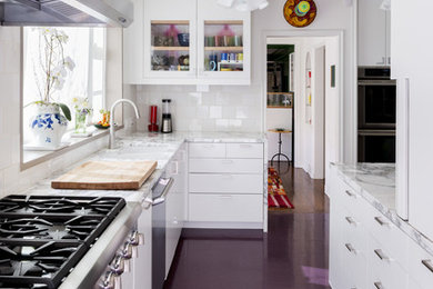 Inspiration for a large transitional l-shaped kitchen remodel in Los Angeles with glass-front cabinets, white cabinets, marble countertops, stainless steel appliances and no island