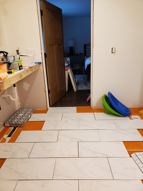 Lay tile parallel or perpendicular to soaking tub?