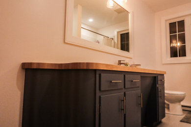 Bathroom - small modern master white tile and ceramic tile porcelain tile, gray floor and single-sink bathroom idea in Other with flat-panel cabinets, blue cabinets, a two-piece toilet, white walls, an undermount sink, wood countertops, beige countertops, a niche and a built-in vanity