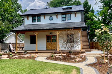 Mid-sized cottage white two-story wood and board and batten exterior home idea in Denver