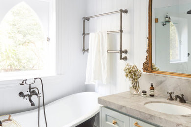 Photo of a traditional master bathroom in Sydney with shaker cabinets, blue cabinets, a claw-foot tub, an open shower, a one-piece toilet, white tile, white walls, mosaic tile floors, an undermount sink, marble benchtops, a single vanity, a floating vanity and panelled walls.