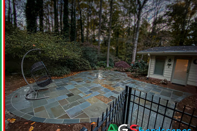 Inspiration for a mid-sized contemporary backyard stone patio remodel in Atlanta with no cover