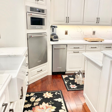 Ivory White Kitchen With Marble Look Quartz Counters and Splash