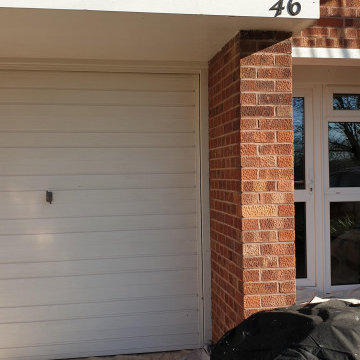 Front exterior - garage door, hand rail, and railing in West Wimbledon