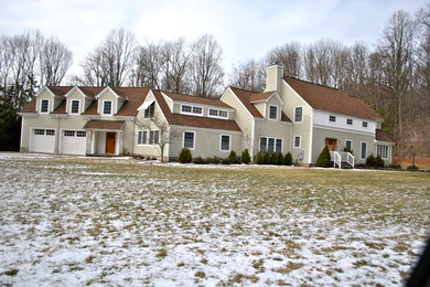 Huge traditional beige two-story wood gable roof idea in New York