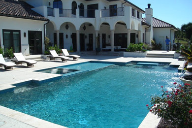 Pool fountain - large traditional backyard concrete paver and rectangular pool fountain idea in Oklahoma City