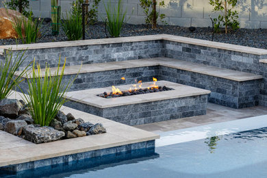 Patio - contemporary backyard tile patio idea in Other