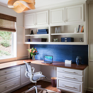 Imagen de despacho bohemio, de tamaño medio, con paredes azules, suelo de bambú y escritorio empotrado