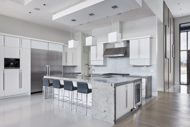 Inspiration for a large modern l-shaped white floor open concept kitchen remodel in Ottawa with a double-bowl sink, flat-panel cabinets, white cabinets, white backsplash, stainless steel appliances, an island and gray countertops