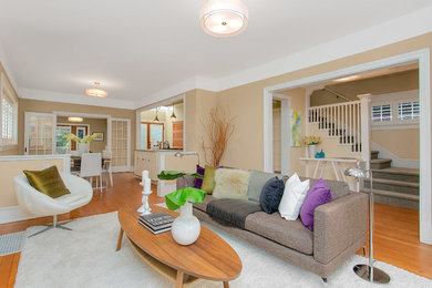 Large minimalist open concept light wood floor living room photo in Seattle with beige walls