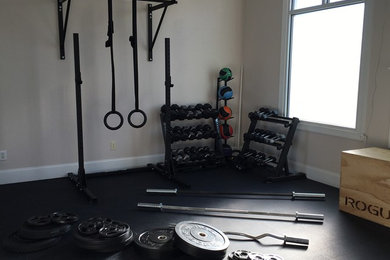 Multiuse home gym - mid-sized industrial black floor multiuse home gym idea in Charlotte with beige walls