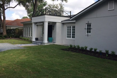 Photo of a mid-sized transitional front door in Orlando with white walls.
