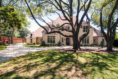 Huge elegant beige two-story stone gable roof photo in Dallas