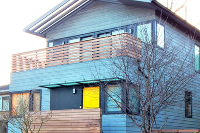 Small minimalist gray three-story wood house exterior photo in Seattle with a hip roof