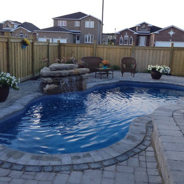 Design build fiberglass pool with a water feature.