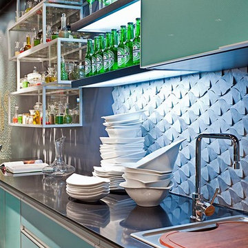 Modern kitchen with blue cabinets and stone mosaic backsplash