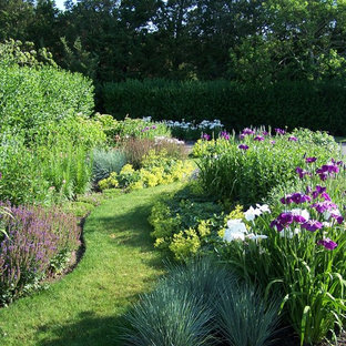 This is an example of a beach style backyard full sun formal garden for spring in New York with mulch.