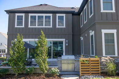 Patio kitchen - transitional backyard concrete paver patio kitchen idea in Columbus