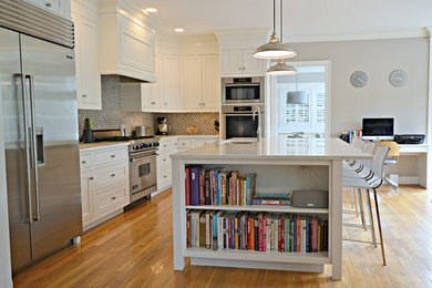 Inspiration for a large modern l-shaped medium tone wood floor and brown floor open concept kitchen remodel in New York with a double-bowl sink, recessed-panel cabinets, white cabinets, quartzite countertops, gray backsplash, mosaic tile backsplash, stainless steel appliances, an island and white countertops