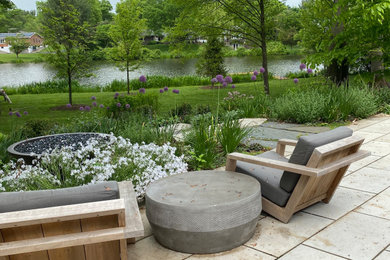 Inspiration for a large contemporary backyard concrete paver patio remodel in Philadelphia with a fire pit