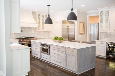 Inspiration for a huge dark wood floor kitchen remodel in Cleveland with a farmhouse sink, shaker cabinets, marble backsplash, stainless steel appliances, an island and white countertops