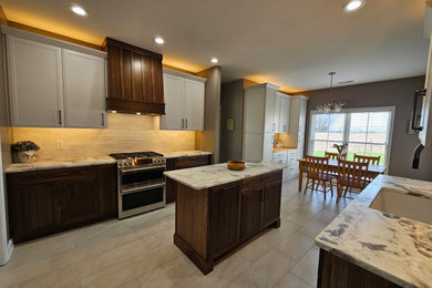 Inspiration for a mid-sized transitional eat-in kitchen remodel in Nashville with shaker cabinets and an island