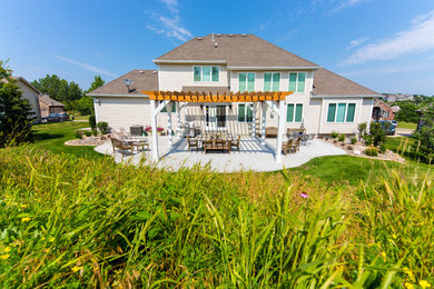 Example of a mid-sized trendy backyard concrete patio design in Other with a pergola