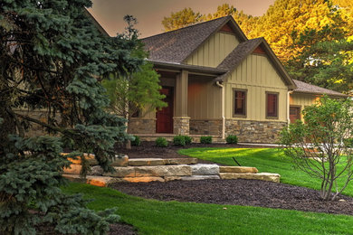 Elegant green one-story mixed siding exterior home photo in Omaha with a shingle roof