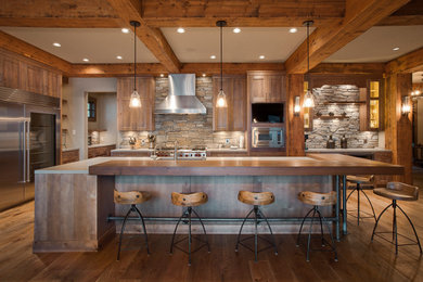 Inspiration for a large country u-shaped eat-in kitchen in Vancouver with shaker cabinets, medium wood cabinets, wood benchtops, grey splashback, stone tile splashback, stainless steel appliances, medium hardwood floors, with island, brown floor and exposed beam.