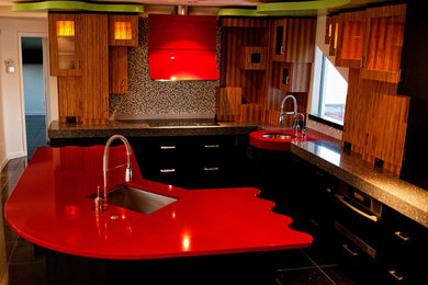Eat-in kitchen - large contemporary l-shaped eat-in kitchen idea in Tampa with a single-bowl sink, glass-front cabinets, granite countertops, gray backsplash, ceramic backsplash, stainless steel appliances and an island