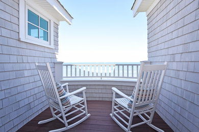 Inspiration for a mid-sized beach style verandah in Salt Lake City with decking, a roof extension and wood railing.
