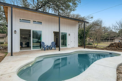 Trendy white one-story tiny house photo in Austin