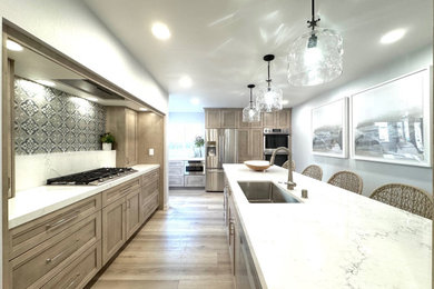 Example of a mid-sized beach style l-shaped vinyl floor and brown floor eat-in kitchen design in Other with an undermount sink, shaker cabinets, light wood cabinets, quartz countertops, blue backsplash, terra-cotta backsplash, stainless steel appliances, a peninsula and white countertops