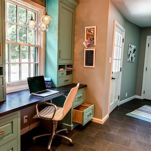 Small transitional study room in Wichita with grey walls, a built-in desk, slate floors, no fireplace and brown floor.