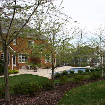 Natural Pool with Travertine Deck & Stone Retaining Wall