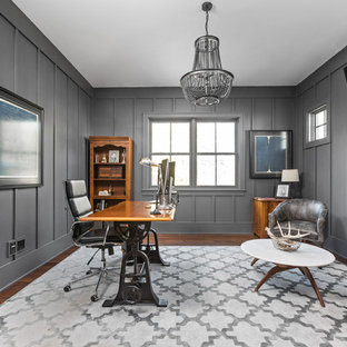 Design ideas for a country study room in Indianapolis with grey walls, dark hardwood floors, a ribbon fireplace, a metal fireplace surround and a freestanding desk.