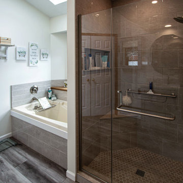Waypoint Gray Shaker Door Cabinetry with Tiled Shower and Matching Tub Surround