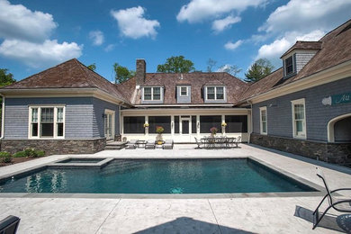 Hot tub - mid-sized transitional backyard concrete paver and rectangular natural hot tub idea in New York