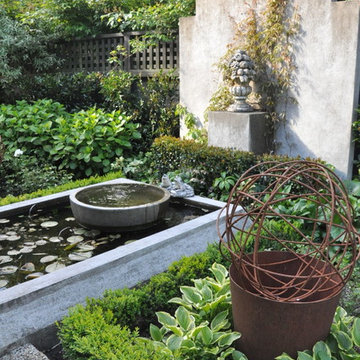 The pond and water bowl beyond the wire sculpture