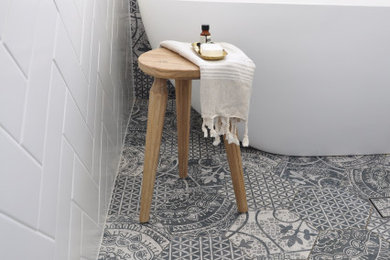 Design ideas for a small midcentury kids bathroom in Canberra - Queanbeyan with white cabinets, a freestanding tub, a corner shower, white tile, ceramic tile, white walls, porcelain floors, an integrated sink, blue floor, a hinged shower door, white benchtops, a niche, a single vanity and a floating vanity.