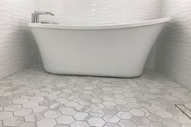 Inspiration for a mid-sized modern master white tile and ceramic tile ceramic tile, gray floor and double-sink bathroom remodel in Edmonton with shaker cabinets, white cabinets, a two-piece toilet, gray walls, an undermount sink, granite countertops, a hinged shower door, white countertops and a built-in vanity