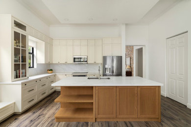 Example of a mid-sized transitional l-shaped laminate floor and brown floor eat-in kitchen design in Miami with a drop-in sink, shaker cabinets, medium tone wood cabinets, quartz countertops, white backsplash, quartz backsplash, stainless steel appliances, an island and white countertops