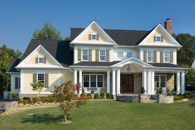 Elegant beige three-story stone exterior home photo in DC Metro