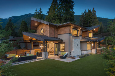 Example of a huge arts and crafts brown two-story mixed siding exterior home design in Vancouver with a shingle roof