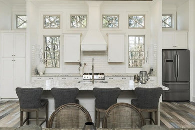 Open concept kitchen - mid-sized transitional single-wall open concept kitchen idea in Atlanta with shaker cabinets, white cabinets, quartzite countertops, white backsplash, subway tile backsplash, an island and white countertops