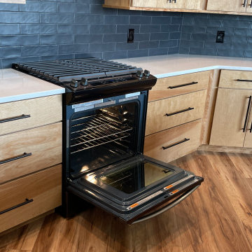 Angled Kitchen Design with Slab Style Cabinets in Pecan Stain