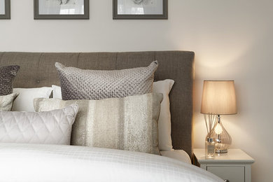Inspiration for a mid-sized timeless master carpeted and gray floor bedroom remodel in Kent with beige walls