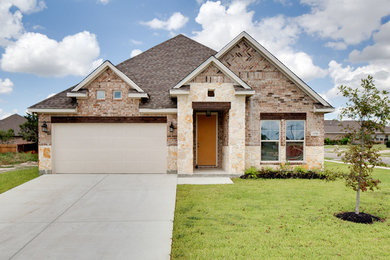 Mid-sized traditional beige one-story brick gable roof idea in Austin